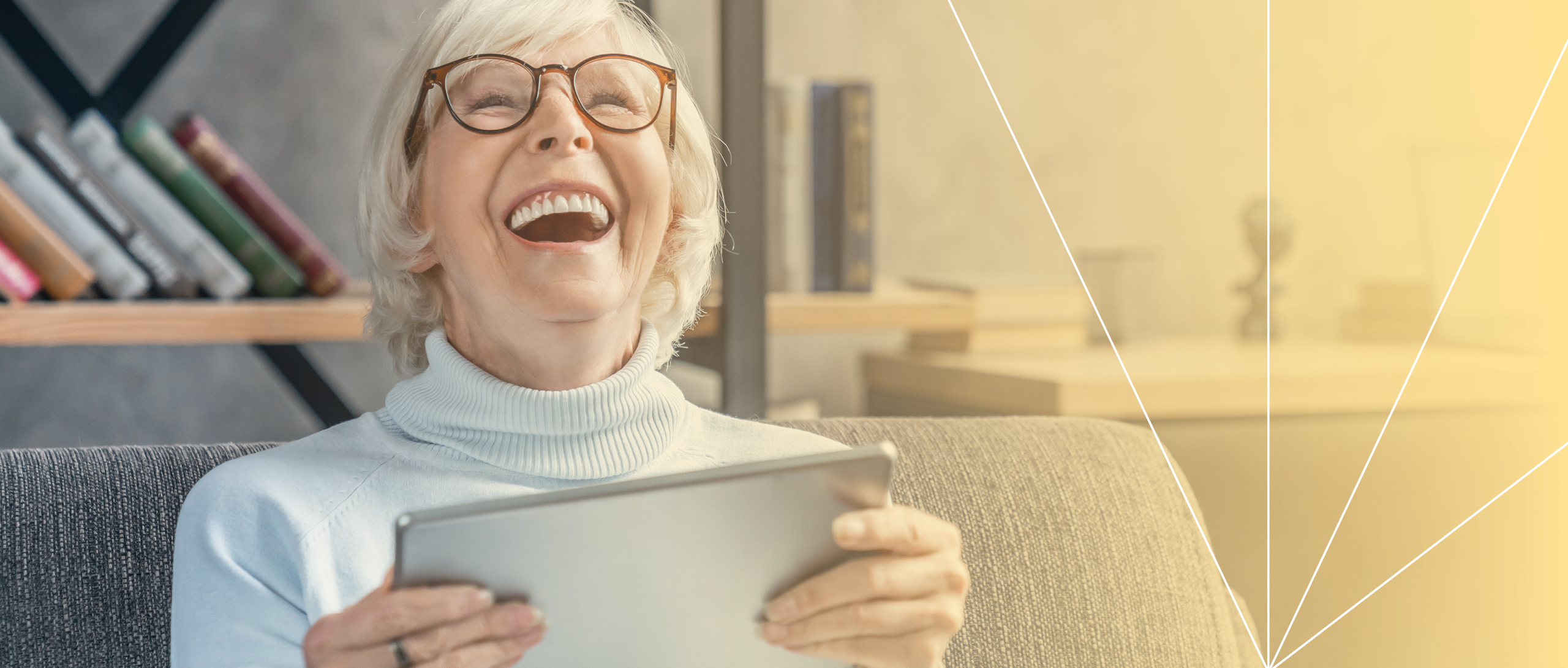 Woman laughing while holding a tablet